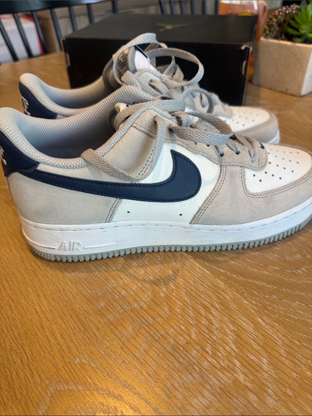 Nike Air Force 1 Low ‘07 LV8 in a grey suede / navy Swoosh colorway.